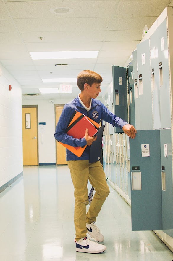A student visits his locker in the Deubner Center.