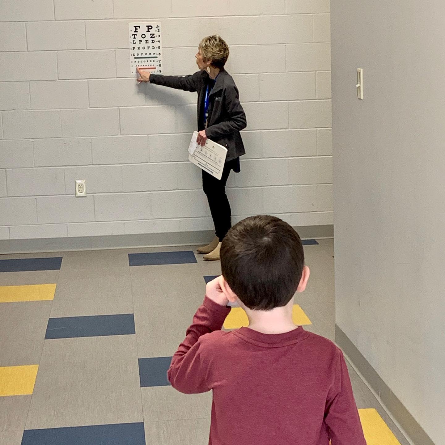 The school nurse tests a student's eyesight